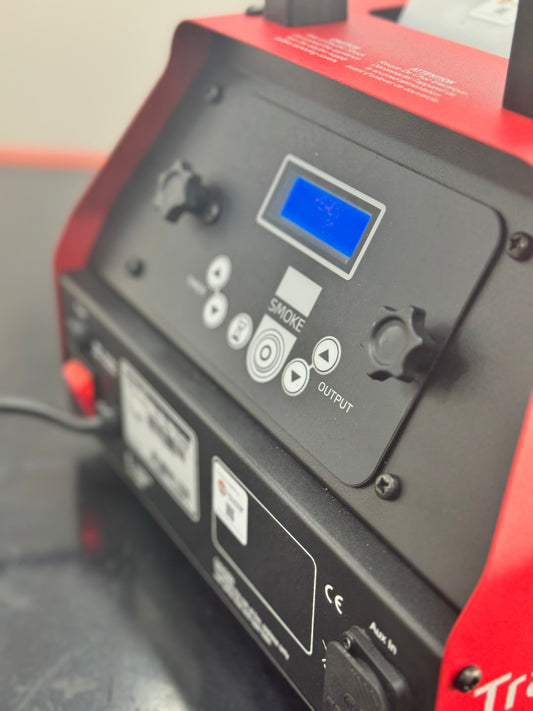 Close-up of the control panel on the 501 smoke Trainer machine, showing display, control buttons, and output settings.