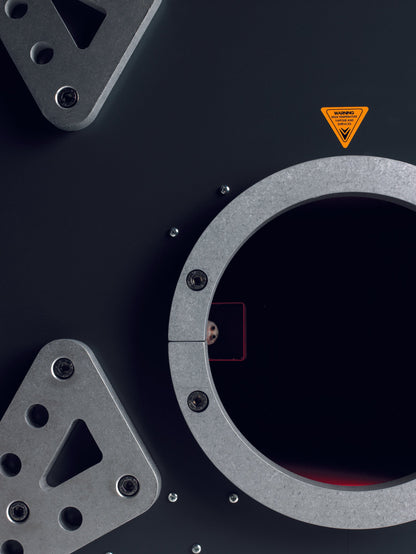 Close-up of MSS Trainer X-Stream smoke machine outlet with circular metal frame, heavy-duty fittings, and warning label.